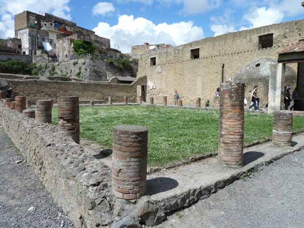 VI.1/7. May 2010. Looking north-west across the palaestra of the men’s baths, from the south-east portico, and near entrances at VI.5 and VI.7.